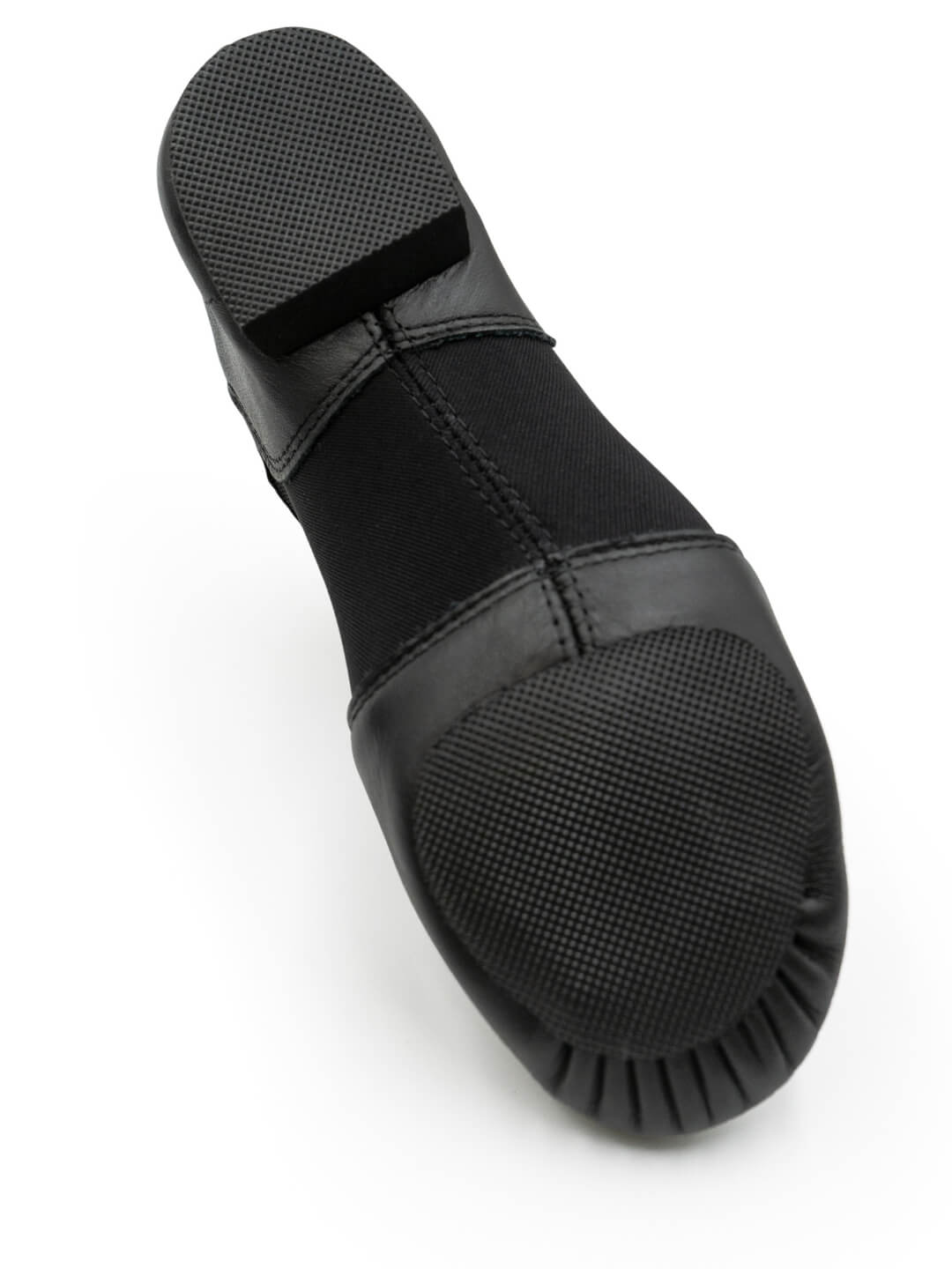 Bottom view of E-Series Jazz Slip On in Black, showing the sole and traction pads on a white background.